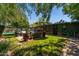 Green backyard with a patio, cozy seating area, mature trees, and privacy at 2908 E Pinchot Ave, Phoenix, AZ 85016
