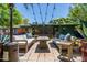 Charming backyard featuring a patio with outdoor seating, a fire pit and overhead string lights at 2908 E Pinchot Ave, Phoenix, AZ 85016