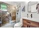 Modern bathroom with a glass-enclosed shower, wooden vanity, and elegant fixtures at 2908 E Pinchot Ave, Phoenix, AZ 85016