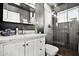 Modern bathroom featuring a marble vanity, sleek gray shower, and sophisticated black and white design elements at 2908 E Pinchot Ave, Phoenix, AZ 85016