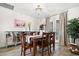 Elegant dining room features a dark wood table, seating for six, stylish chandelier, and French doors at 2908 E Pinchot Ave, Phoenix, AZ 85016