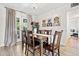 Features a classic dining room with hardwood floors, a wooden table for six, and elegant décor at 2908 E Pinchot Ave, Phoenix, AZ 85016