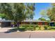 Charming brick home featuring mature trees, a covered carport, and well-maintained landscaping at 2908 E Pinchot Ave, Phoenix, AZ 85016