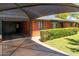 Charming red brick home featuring a carport and manicured front lawn, with lush hedges at 2908 E Pinchot Ave, Phoenix, AZ 85016