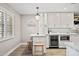 Bright kitchen with white cabinets, a granite countertop, pendant lighting, and stainless-steel appliances at 2908 E Pinchot Ave, Phoenix, AZ 85016
