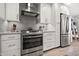 Modern kitchen with stainless steel appliances, white cabinets, and granite countertops at 2908 E Pinchot Ave, Phoenix, AZ 85016