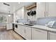 Well-lit kitchen featuring white cabinetry, granite countertops, and modern stainless steel fixtures at 2908 E Pinchot Ave, Phoenix, AZ 85016