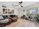 Bright living room featuring modern decor, hardwood floors, and a comfortable leather sectional sofa at 2908 E Pinchot Ave, Phoenix, AZ 85016