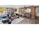 Features a spacious living room with wood flooring, a brick wall accent, and comfortable seating near a pool view at 2908 E Pinchot Ave, Phoenix, AZ 85016