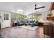 Bright living room with large windows, wood floors, ceiling fan, and neutral-toned sofas surrounding a modern area rug at 2908 E Pinchot Ave, Phoenix, AZ 85016
