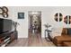 Living room featuring hardwood floors, stylish decor, and an open view into the dining room at 2908 E Pinchot Ave, Phoenix, AZ 85016