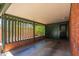 Covered brick patio with open railing, offering outdoor space for relaxation with greenery views at 2908 E Pinchot Ave, Phoenix, AZ 85016