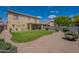 Large backyard with a covered patio, green lawn, and desert landscaping at 2911 W Keim Dr, Phoenix, AZ 85017