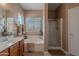Bathroom with a soaking tub, walk-in shower, double sink vanity, and window at 2911 W Keim Dr, Phoenix, AZ 85017
