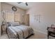 Bedroom featuring a bed, window with blinds, and clock at 2911 W Keim Dr, Phoenix, AZ 85017