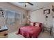 Bedroom featuring a bed, window with blinds, and decorative wall hangings at 2911 W Keim Dr, Phoenix, AZ 85017