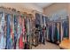 Walk-in closet with window and clothing racks filled with shoes and clothes at 2911 W Keim Dr, Phoenix, AZ 85017