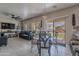 Open dining area with a glass table, sliding doors to the backyard, and views to the living room at 2911 W Keim Dr, Phoenix, AZ 85017