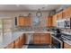 Clean kitchen featuring light wood cabinetry, stainless steel appliances and access to backyard at 2911 W Keim Dr, Phoenix, AZ 85017