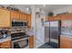 Well-equipped kitchen featuring stainless steel appliances, tiled backsplash, and wood cabinets at 2911 W Keim Dr, Phoenix, AZ 85017