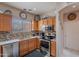 Bright kitchen featuring wooden cabinets, modern appliances, and a decorative tile backsplash at 2911 W Keim Dr, Phoenix, AZ 85017