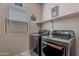 Laundry area with modern washer and dryer, ample lighting and neutral color walls at 2911 W Keim Dr, Phoenix, AZ 85017