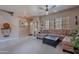 Comfortable living area with a cozy sectional sofa, ceiling fan, and access to the front entryway at 2911 W Keim Dr, Phoenix, AZ 85017
