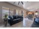 Comfortable living room with a black leather sofa, a sliding glass door, and a view to the kitchen at 2911 W Keim Dr, Phoenix, AZ 85017