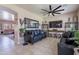 Comfortable living area with a black leather sofa, a ceiling fan, and stylish decor at 2911 W Keim Dr, Phoenix, AZ 85017