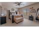 Spacious main bedroom with a ceiling fan, carpet, and natural light at 2911 W Keim Dr, Phoenix, AZ 85017