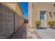 Paved side yard with potted plants, stone path, and privacy wall at 2911 W Keim Dr, Phoenix, AZ 85017