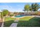 Backyard retreat featuring a sparkling pool, desert landscape, and a stepping stone pathway at 2930 E Quiet Hollow Ln, Phoenix, AZ 85024