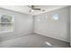 A cozy bedroom with neutral carpet, grey walls, and bright window views at 2930 E Quiet Hollow Ln, Phoenix, AZ 85024