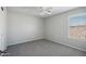 Carpeted bedroom with ceiling fan and bright window at 2930 E Quiet Hollow Ln, Phoenix, AZ 85024