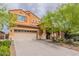 Inviting two-story home with a well-manicured lawn, mature trees, and a spacious three-car garage at 2930 E Quiet Hollow Ln, Phoenix, AZ 85024