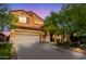 Charming home with a large driveway, a two-car garage, and desert landscaping at 2930 E Quiet Hollow Ln, Phoenix, AZ 85024