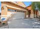 Two-car garage featuring a concrete driveway and desert landscaping at 2930 E Quiet Hollow Ln, Phoenix, AZ 85024