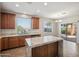 The eat-in kitchen features a central island, granite counters, stainless appliances, and backyard views at 2930 E Quiet Hollow Ln, Phoenix, AZ 85024