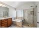Clean bathroom featuring a soaking tub, glass shower, and tile accents at 2930 E Quiet Hollow Ln, Phoenix, AZ 85024