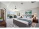 Spacious main bedroom featuring a ceiling fan and a view of the desert landscape at 2930 E Quiet Hollow Ln, Phoenix, AZ 85024