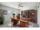 Office with a large desk, bookcase, ceiling fan, and window with blinds at 2930 E Quiet Hollow Ln, Phoenix, AZ 85024