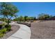 Community pathway with stone wall and landscaping to enhance the beauty of the area at 2930 E Quiet Hollow Ln, Phoenix, AZ 85024