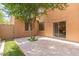 Private backyard patio with stone pavers, a shade tree, and access to the home via sliding glass door at 2930 E Quiet Hollow Ln, Phoenix, AZ 85024
