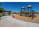 Community playground boasts covered picnic area and play structure with slides and climbing bars at 2930 E Quiet Hollow Ln, Phoenix, AZ 85024