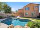 Backyard pool features flagstone surround, rock accents, and lawn at 2930 E Quiet Hollow Ln, Phoenix, AZ 85024
