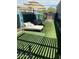 Landscaped backyard oasis with turf, daybed, and umbrella for relaxing outdoors at 30440 N 42Nd Pl, Cave Creek, AZ 85331