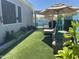 Serene backyard with green turf, chaise lounge, privacy landscaping and patio umbrella at 30440 N 42Nd Pl, Cave Creek, AZ 85331