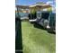 Lush backyard with artificial turf, pergola, lounge furniture, and well-manicured landscaping at 30440 N 42Nd Pl, Cave Creek, AZ 85331