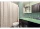 Bathroom featuring glass countertop sink, decorative mirror, and shower curtain at 30440 N 42Nd Pl, Cave Creek, AZ 85331