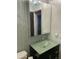 Bathroom boasts blue decorative accent walls and a green glass vanity, crowned by a unique aqua chandelier at 30440 N 42Nd Pl, Cave Creek, AZ 85331